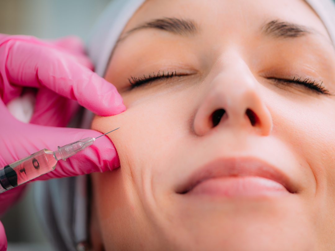 A picture of a clinician injecting dermal filler into a patients cheek
